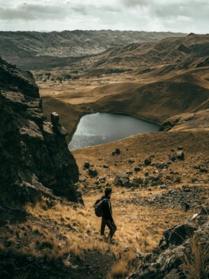 Exploring the rugged beauty of Langui, Cuzco with a serene mountain lake view and dramatic landscapes.