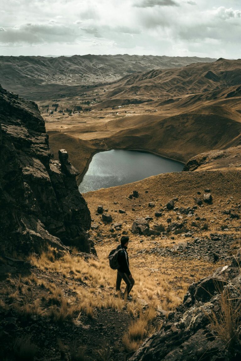Exploring the rugged beauty of Langui, Cuzco with a serene mountain lake view and dramatic landscapes.